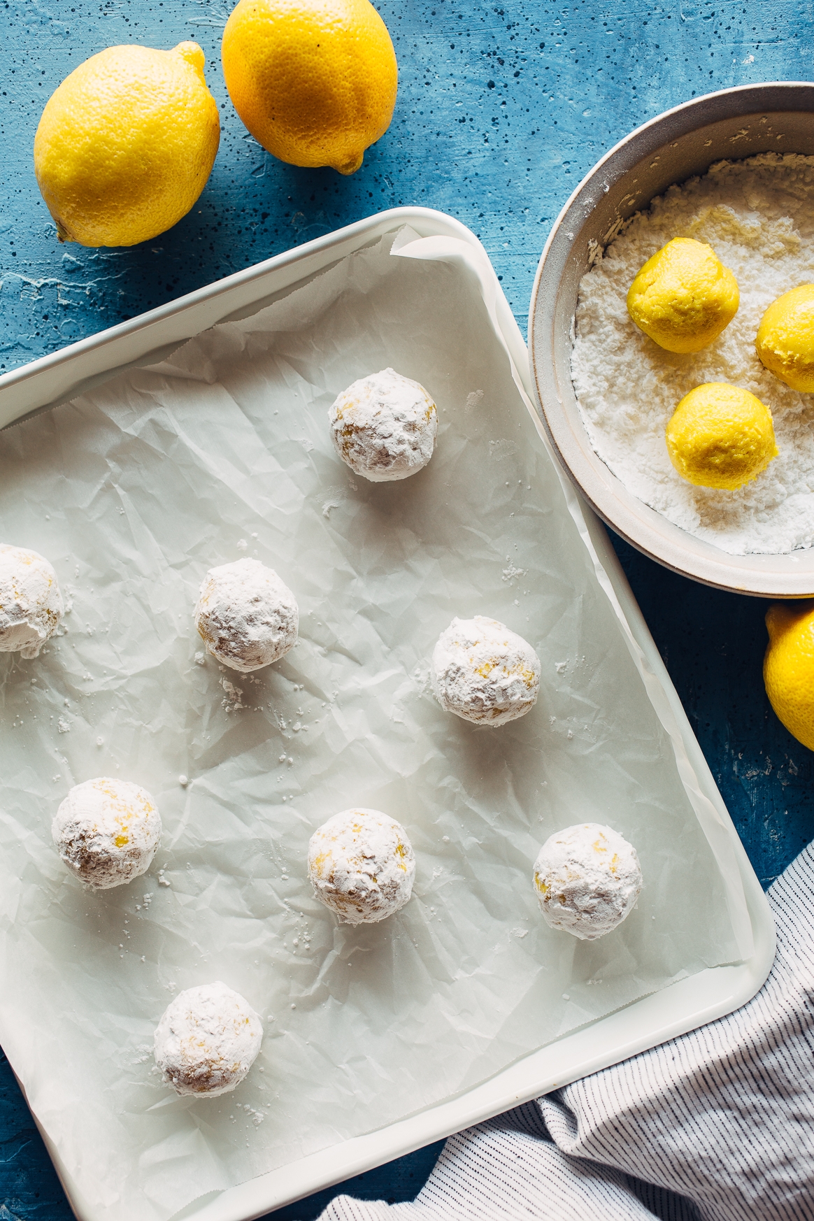 Rolling Crinkle Cookies in Powdered Sugar